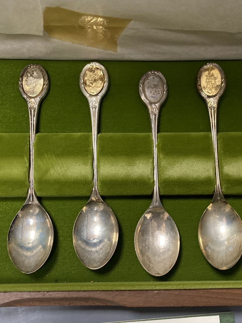 A modern cased set of twelve parcel gilt silver Royal Horticultural Society Flower Spoons by John Pinches,